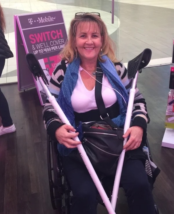 Debi Robinson on crutches after her hip replacement surgery