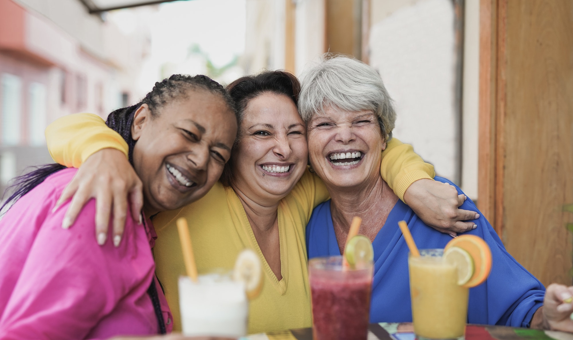 Multiracial senior women taking a selife at bar terrace
