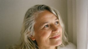 A woman reflecting hopefully by a window